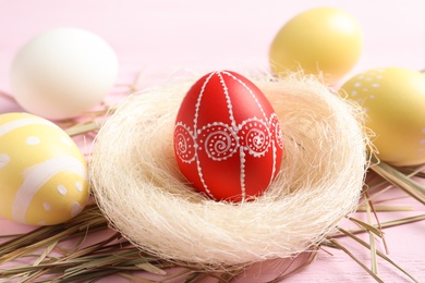 Photo of Composition with painted Easter eggs on table