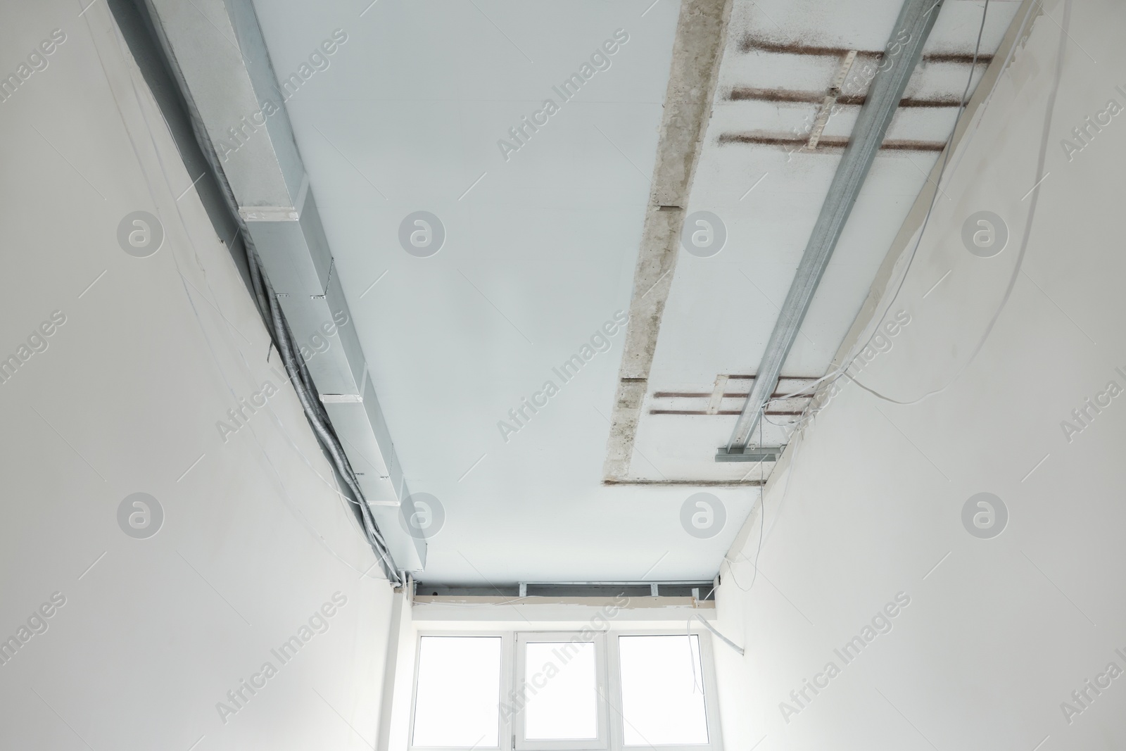 Photo of Ceiling with wires prepared for renovation in room