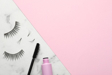 Photo of False eyelashes and mascara on color background, flat lay. Space for text