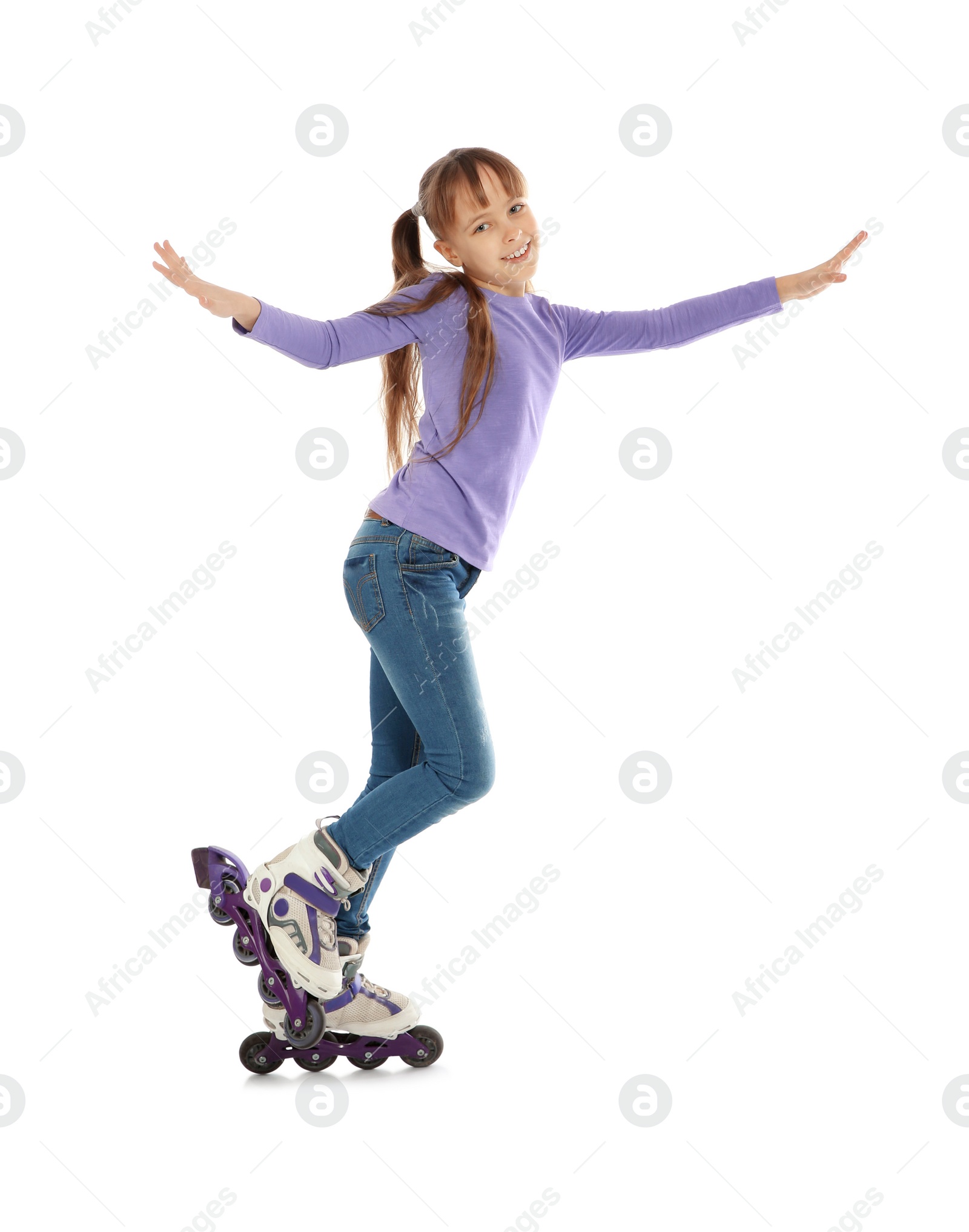 Photo of Little girl with inline roller skates on white background