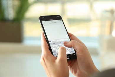 Photo of Woman writing message with text I Love You on smartphone against blurred background, closeup