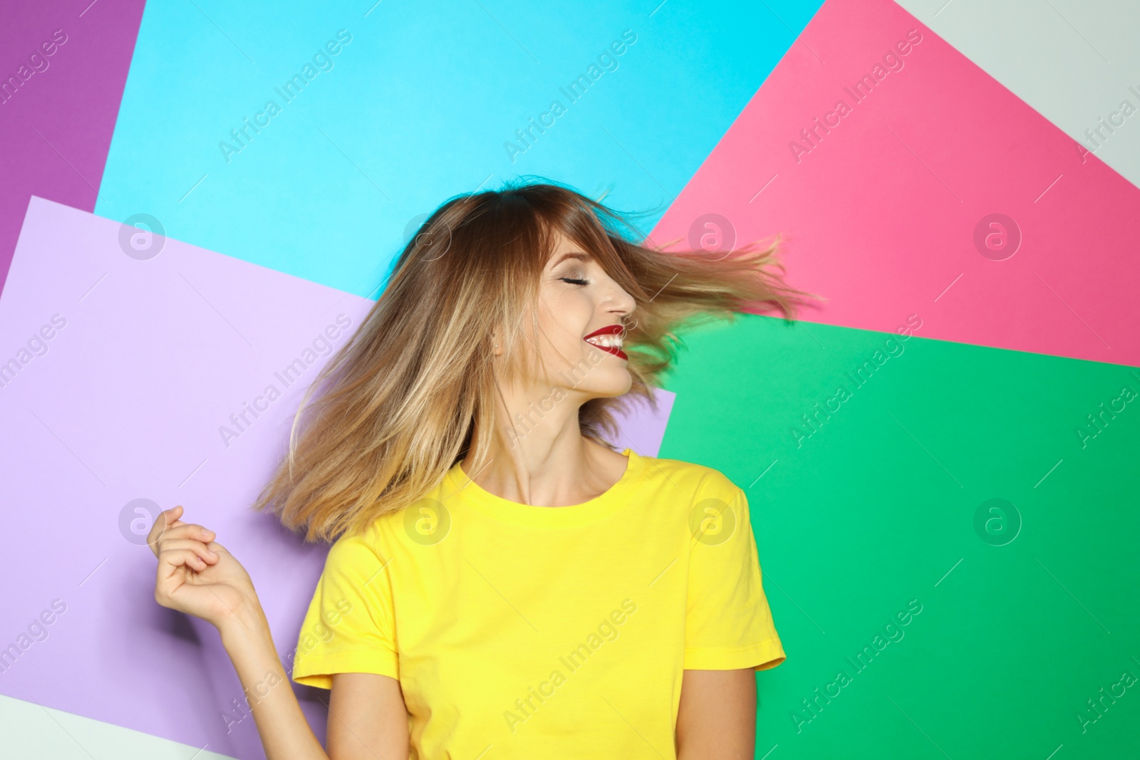 Photo of Beautiful young woman with healthy long blonde hair on color background