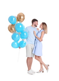 Young couple with air balloons on white background