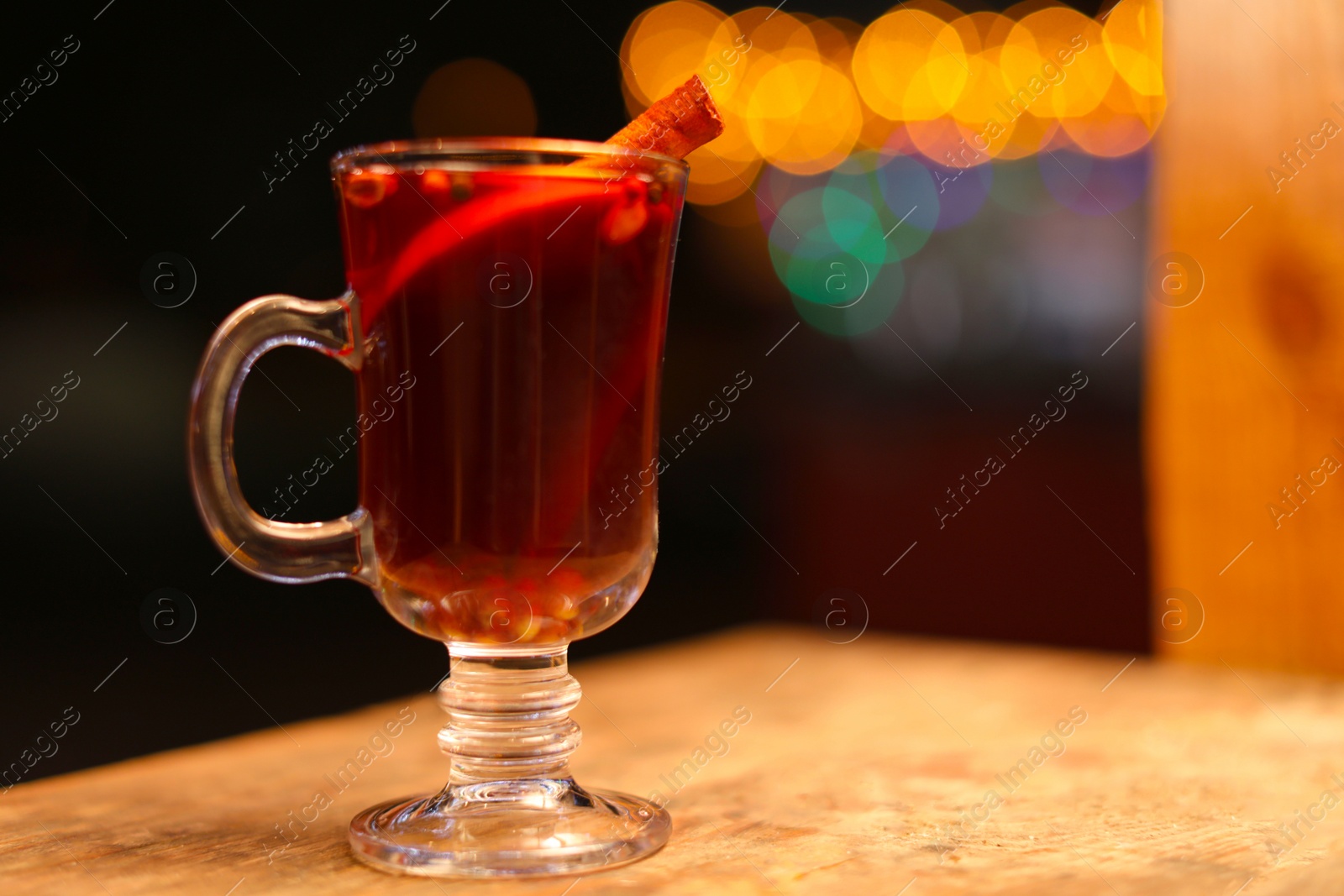 Photo of Tasty aromatic mulled wine on table at winter fair