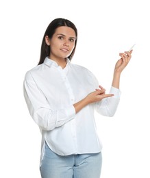 Beautiful young woman pointing at something with pen on white background. Weather forecast reporter