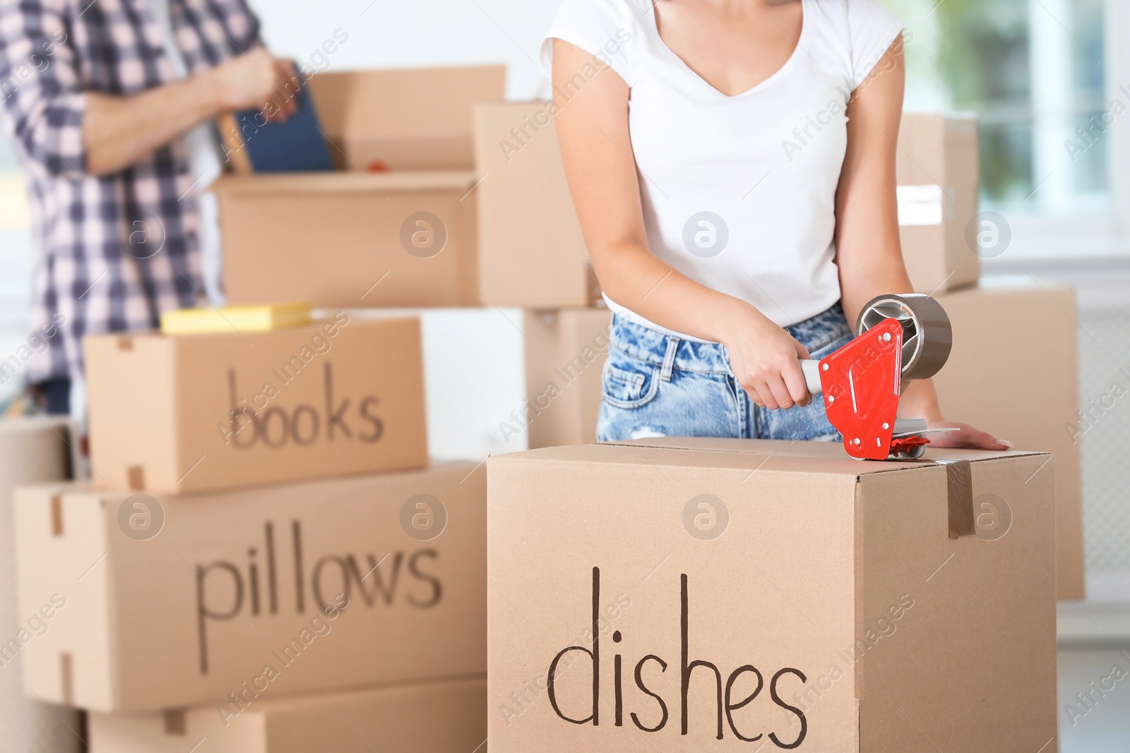 Photo of Woman packing box indoors, closeup. Moving day