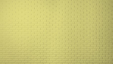 Texture of pale golden rod color brick wall as background