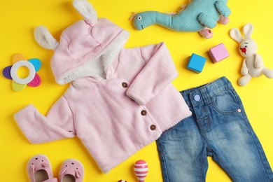 Flat lay composition with cute clothes on color background. Baby accessories