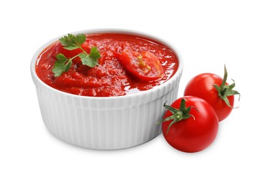 Photo of Homemade tomato sauce in bowl and fresh ingredients isolated on white