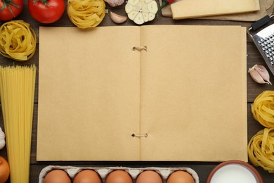 Blank recipe book and different ingredients on wooden table, flat lay. Space for text