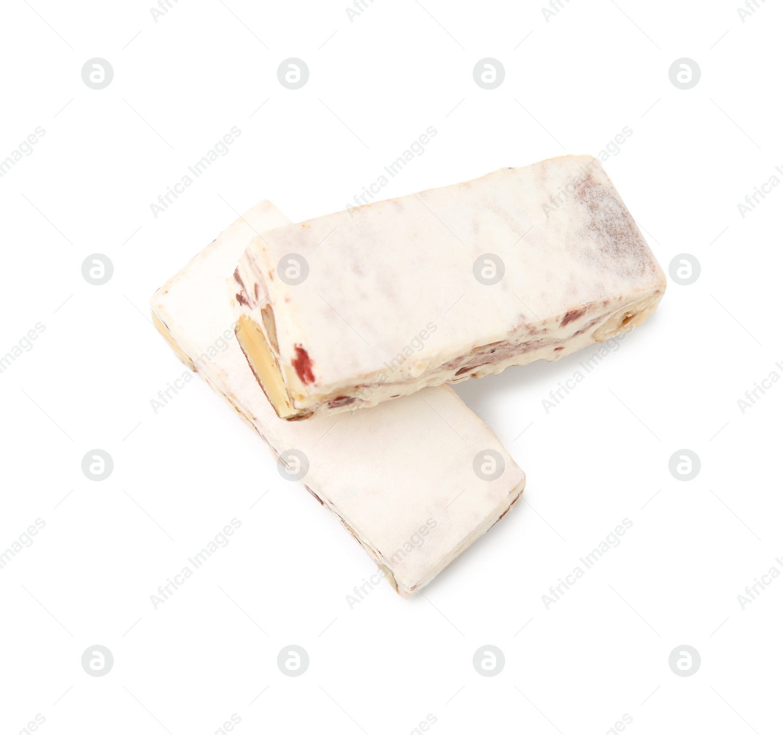 Photo of Pieces of delicious nougat on white background, top view