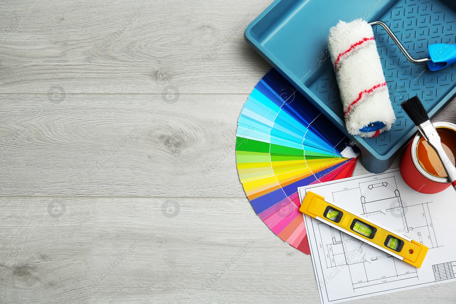 Photo of Set of decorator's tools on wooden floor