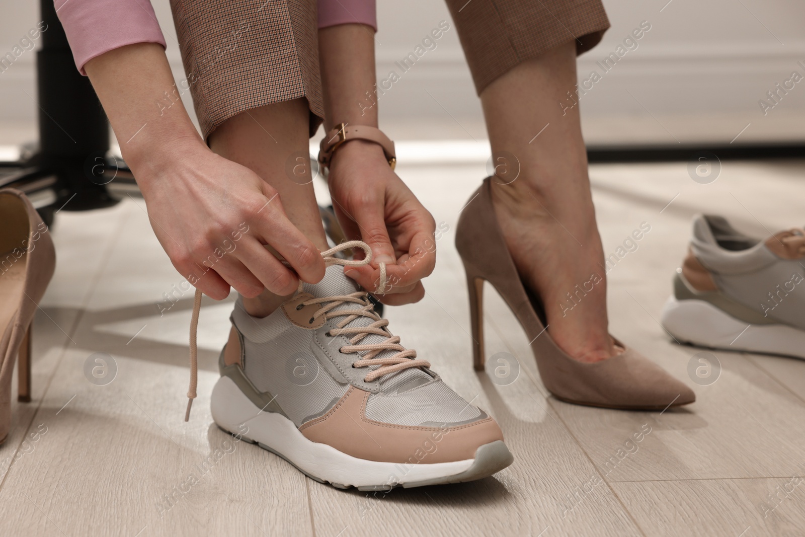 Photo of Woman changing shoes in office, closeup view