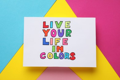 Photo of Words Live Your Life In Colors on bright colorful background, top view