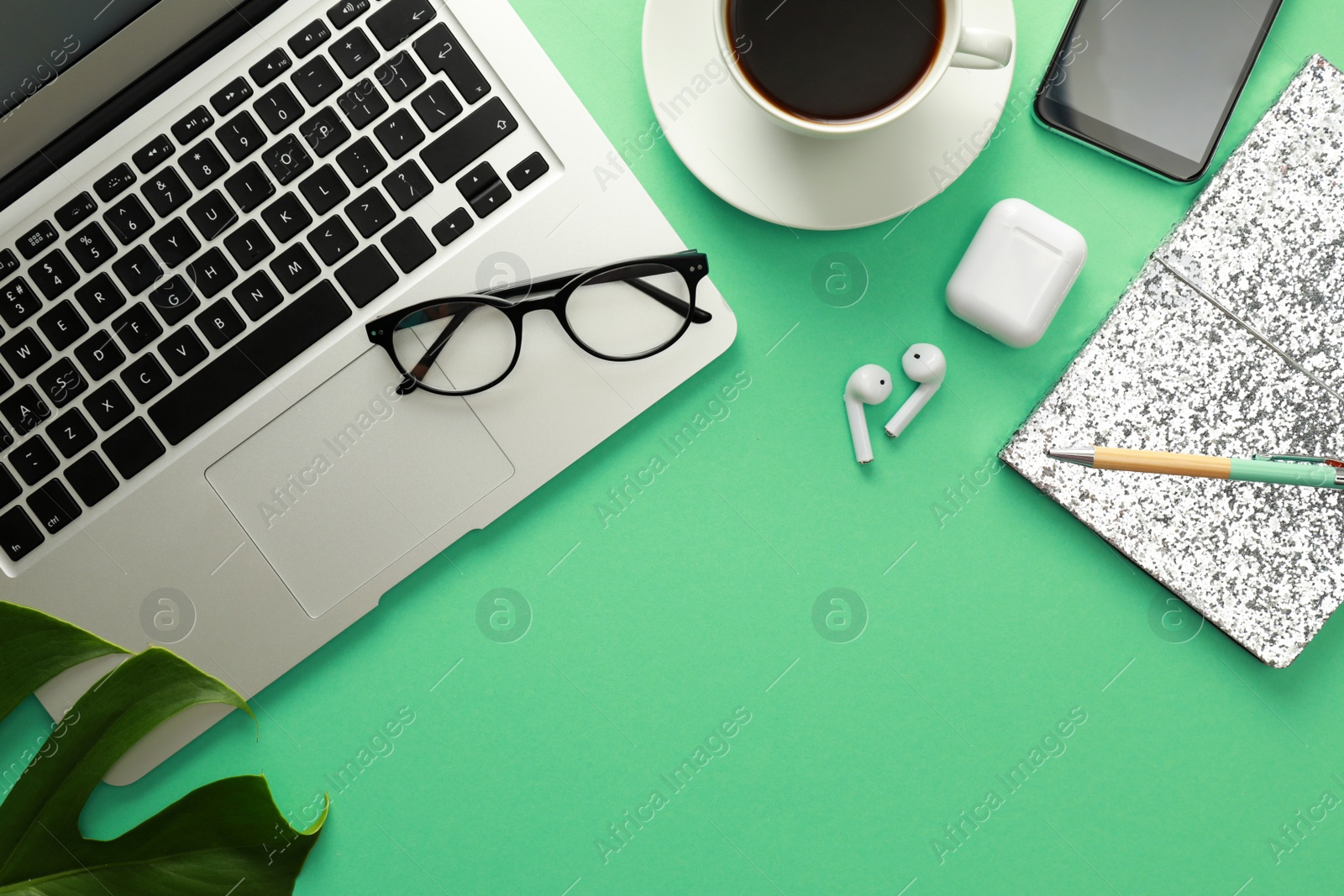 Photo of Flat lay composition with laptop on green background. Fashion blogger