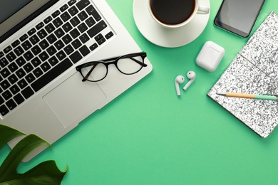 Photo of Flat lay composition with laptop on green background. Fashion blogger