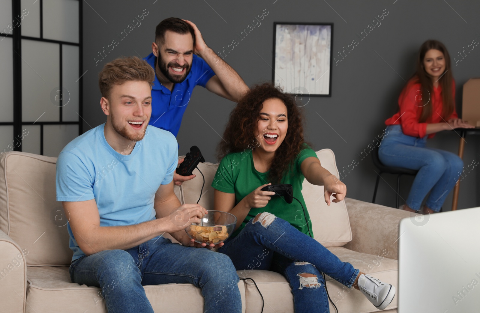 Photo of Emotional friends playing video games at home