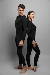 Photo of Couple wearing thermal underwear on grey background