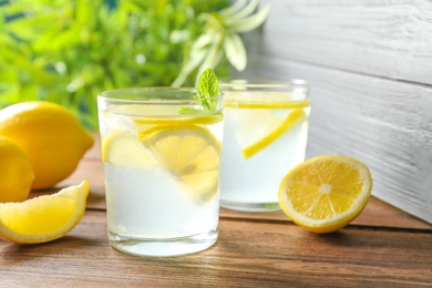 Natural lemonade with mint in glasses on wooden table