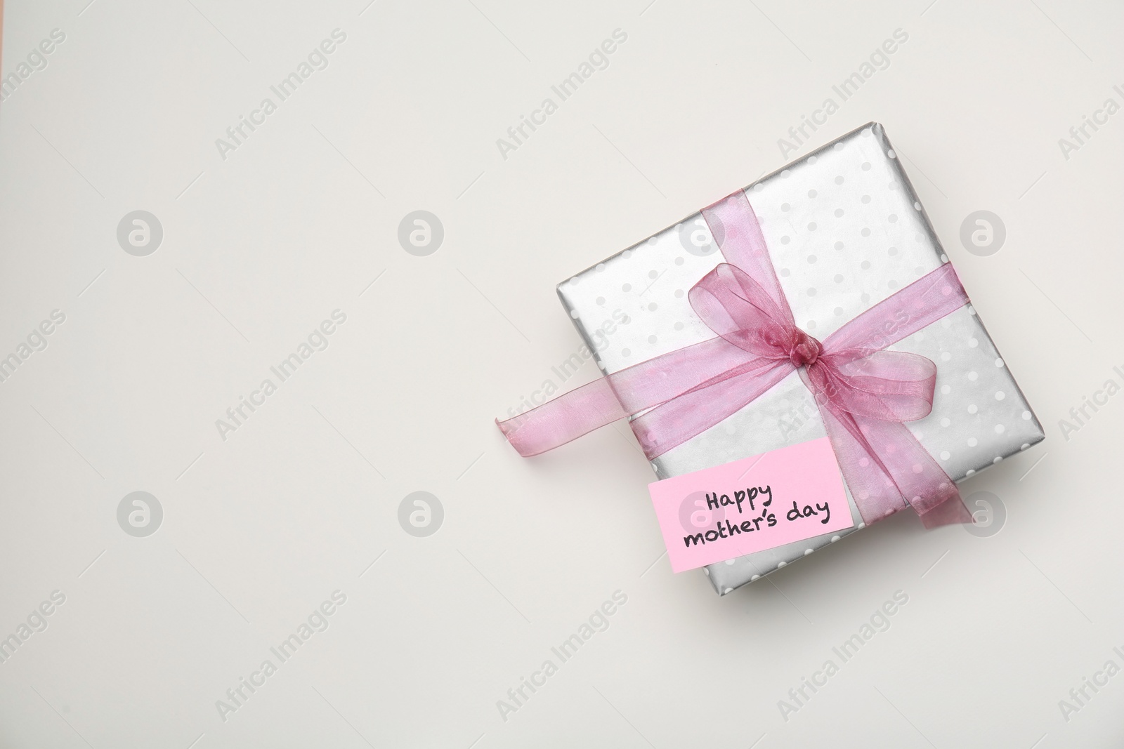 Photo of Elegant gift box for Mother's Day on light background, top view