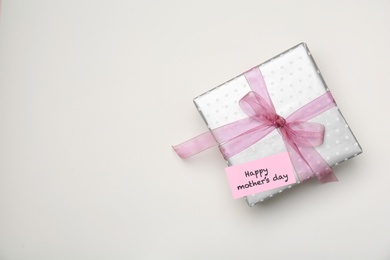 Photo of Elegant gift box for Mother's Day on light background, top view