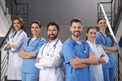 Photo of Teamprofessional doctors on staircase in clinic