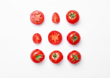 Photo of Flat lay composition with ripe tomatoes on light background