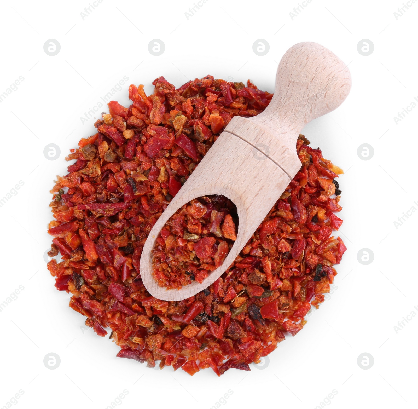 Photo of Aromatic spice. Pile of red chili pepper flakes and scoop isolated on white, top view