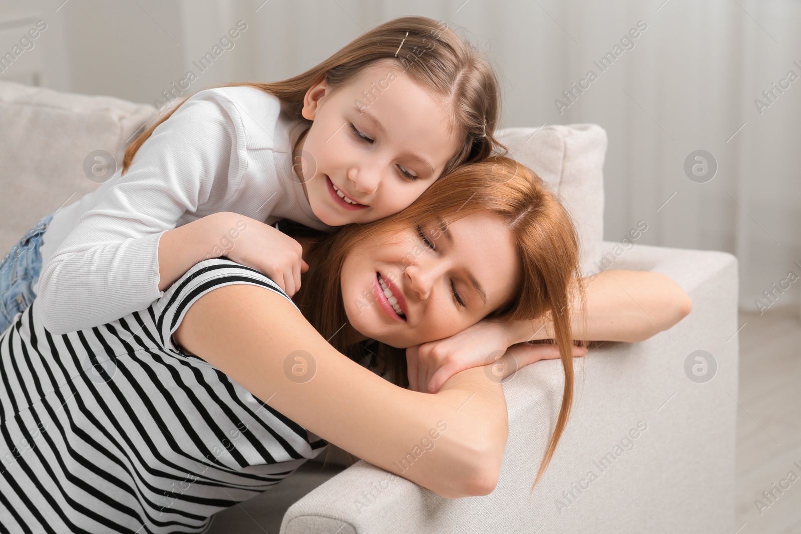 Photo of Mother and her cute daughter spending time together at home