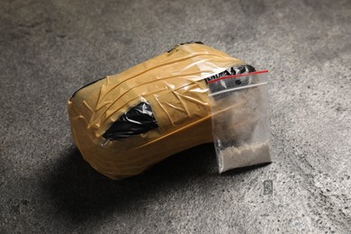 Photo of Packages with narcotics on grey textured table