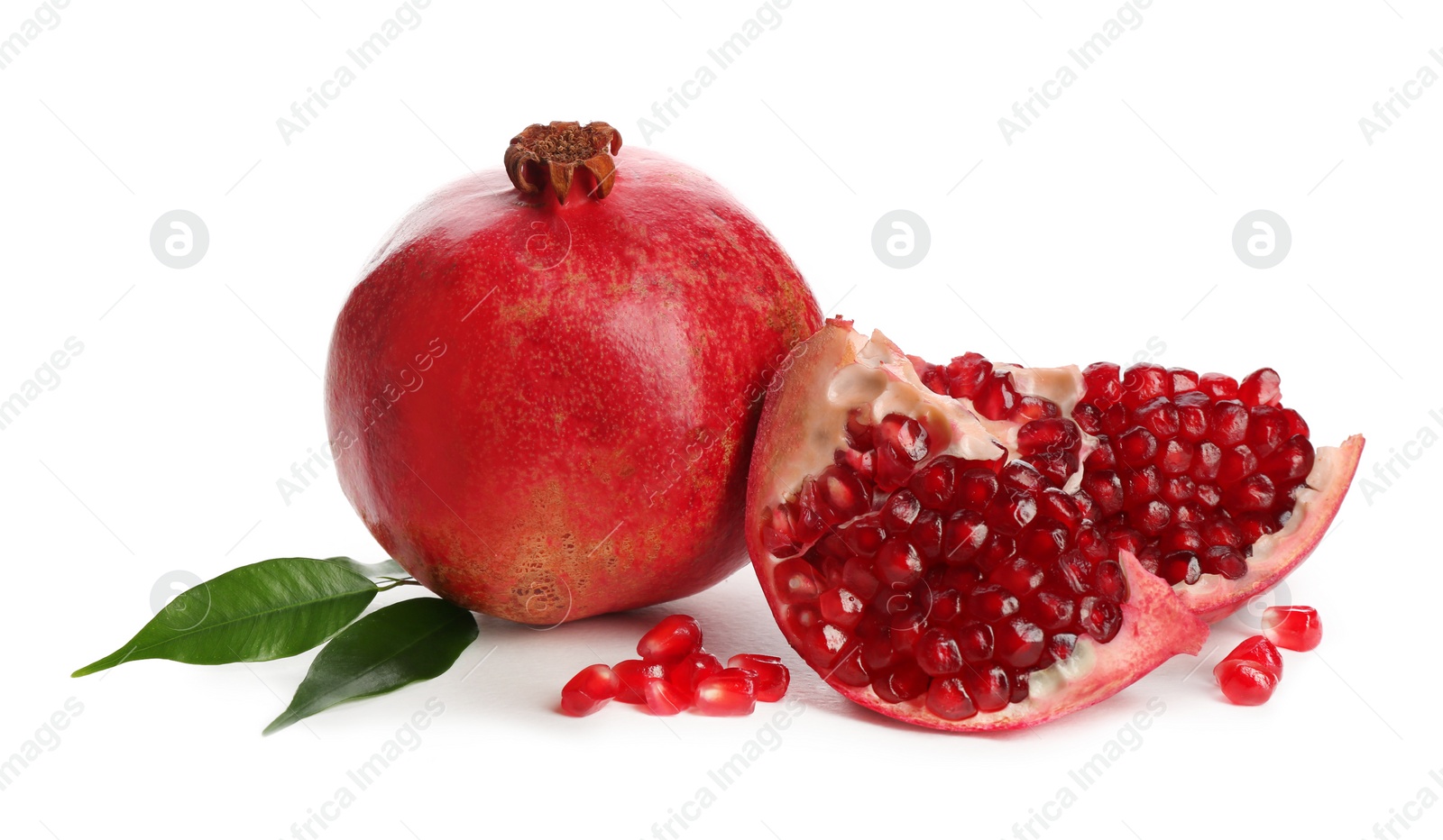 Photo of Ripe pomegranates with leaves on white background