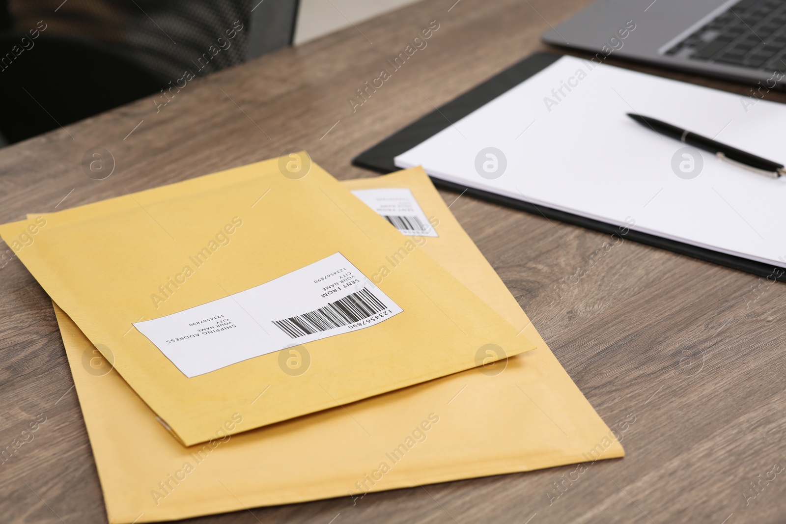 Photo of Parcels on wooden table in office. Online store