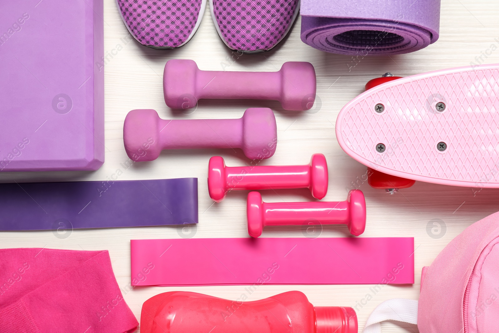 Photo of Different sports equipment on white wooden table, flat lay