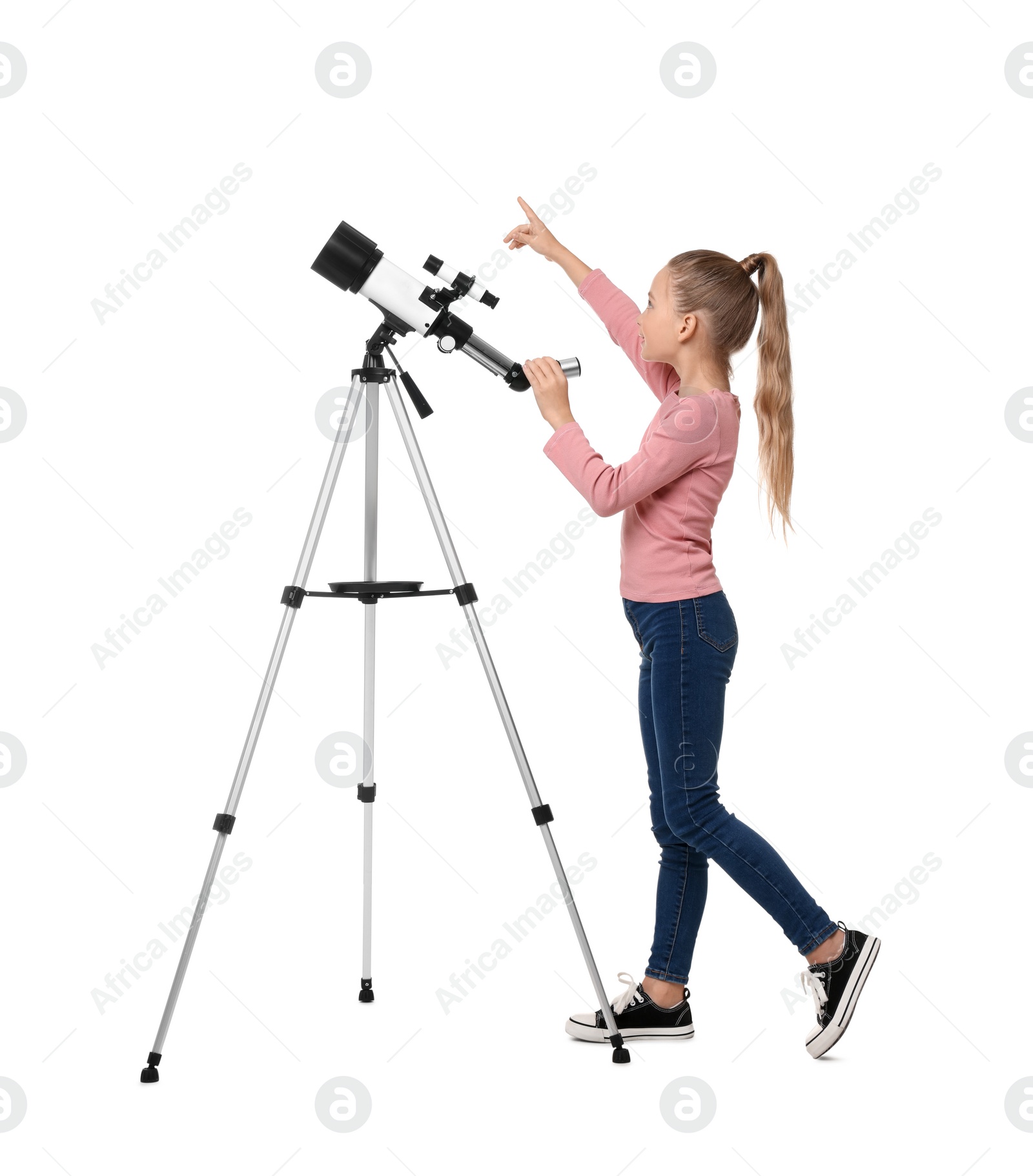 Photo of Happy little girl with telescope pointing at something on white background