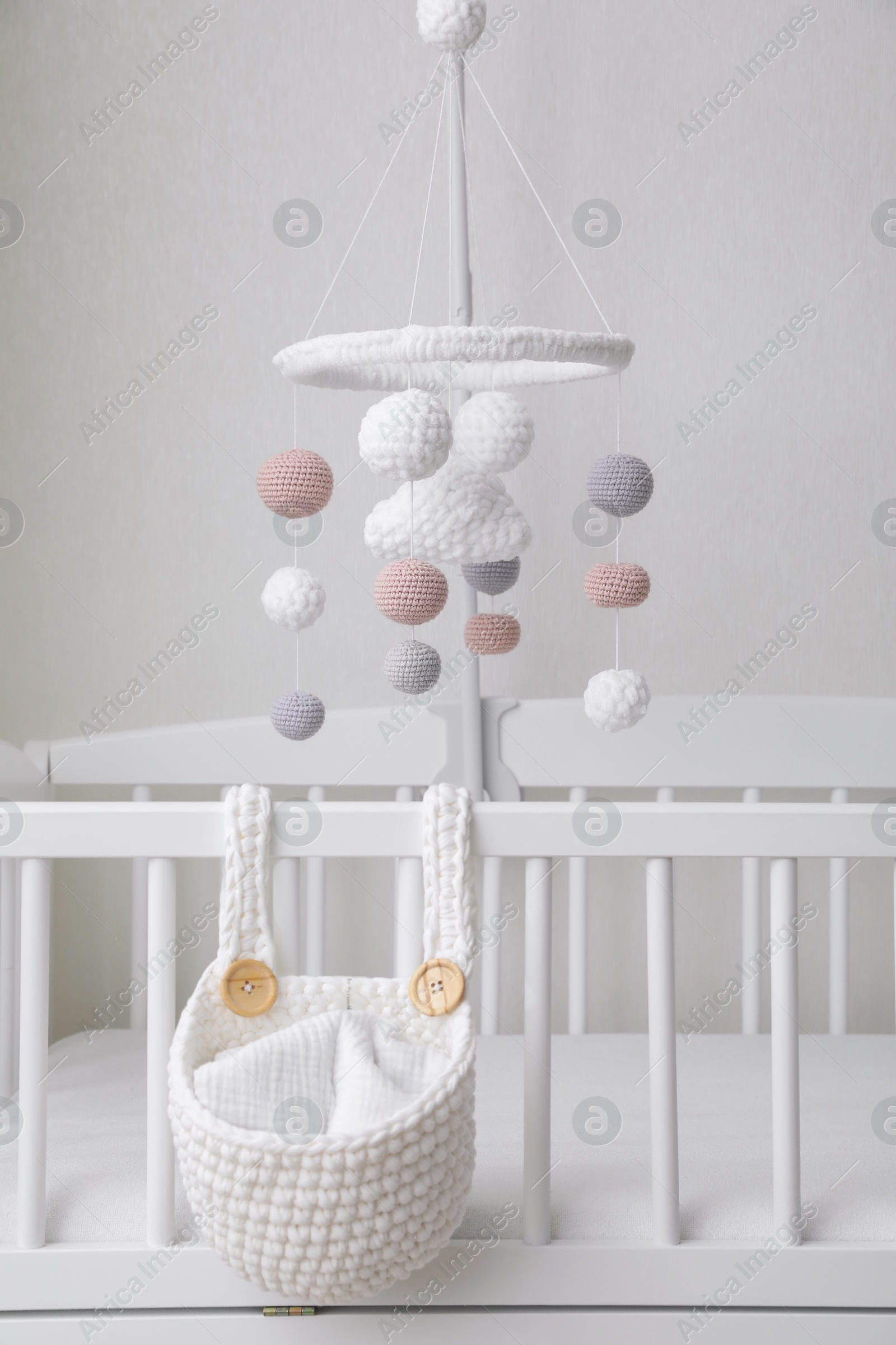 Photo of Modern baby mobile under crib in children's room