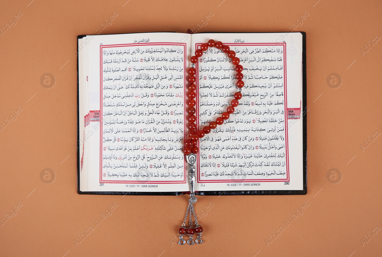 Photo of Muslim prayer beads and Quran on color background, top view