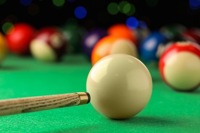 Classic plain billiard ball and cue on green table