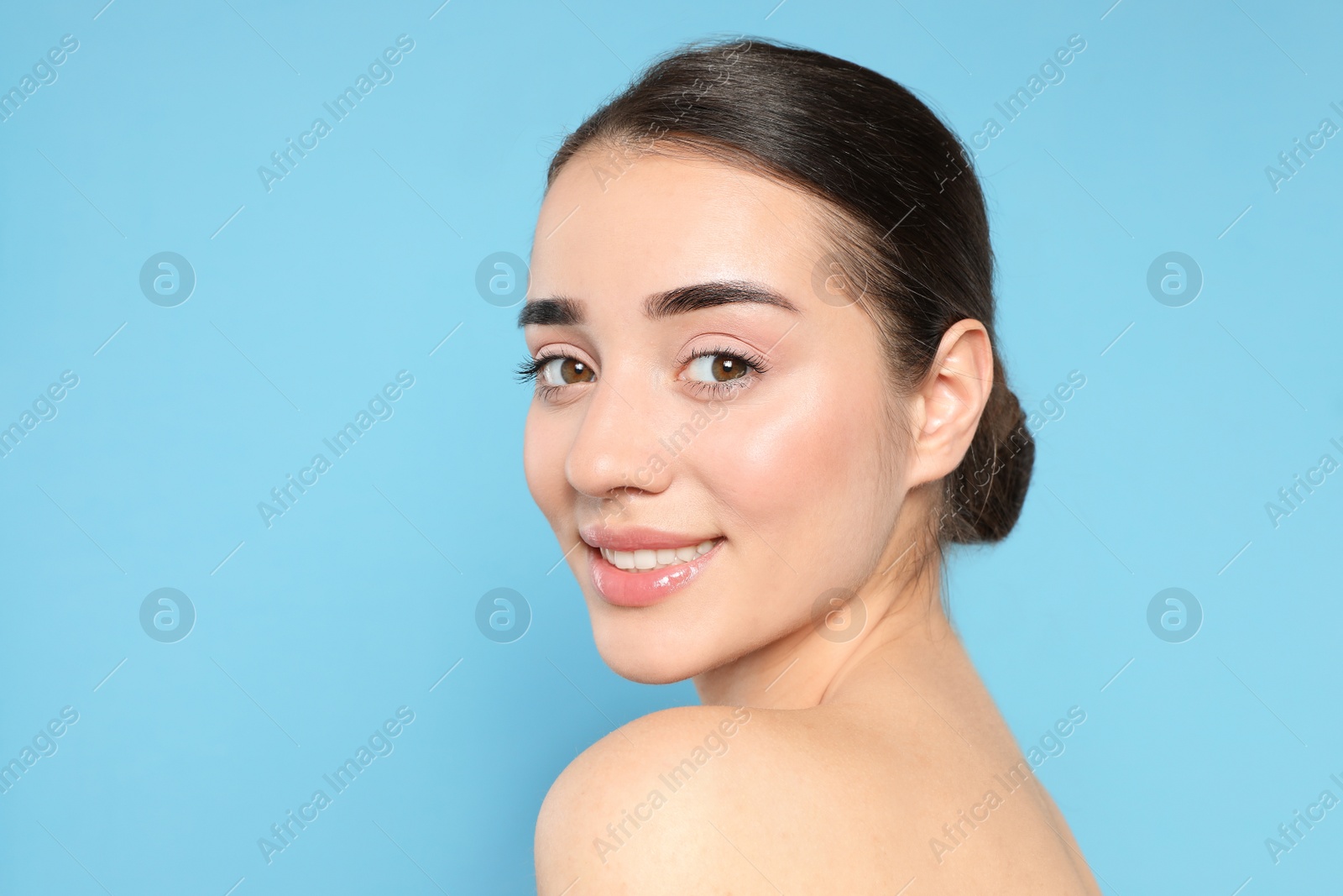 Photo of Portrait of young woman with beautiful face against color background