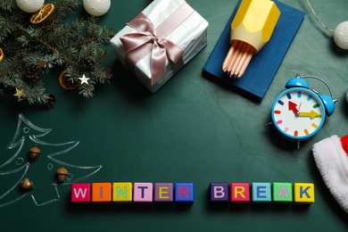 Photo of Colorful cubes with text Winter Break and Christmas decor on green background, flat lay. School holidays