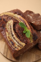 Delicious banana bread with mint on beige background, closeup