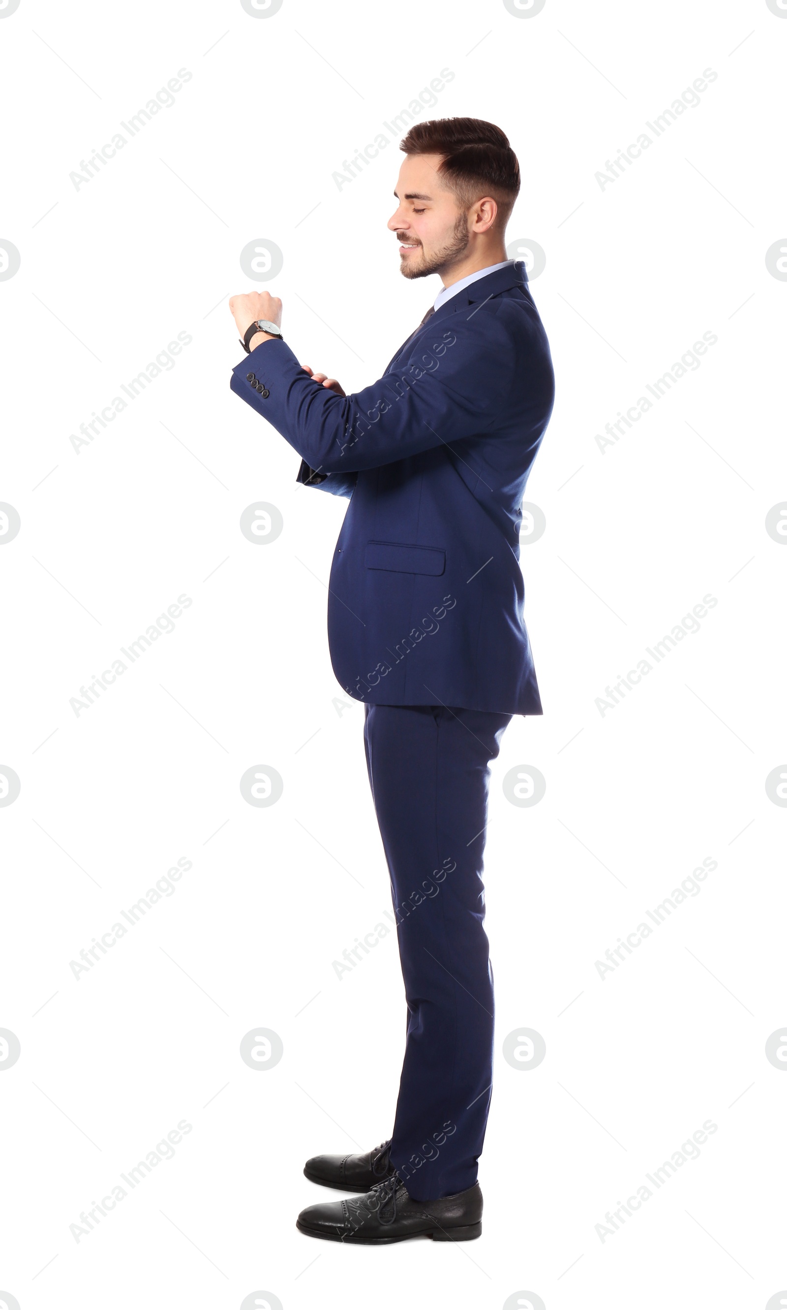 Photo of Full length portrait of businessman looking at wrist watch on white background