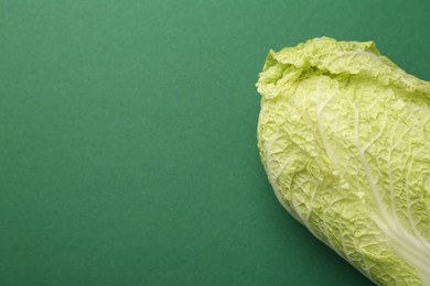 Photo of Fresh ripe Chinese cabbage on green background, top view. Space for text