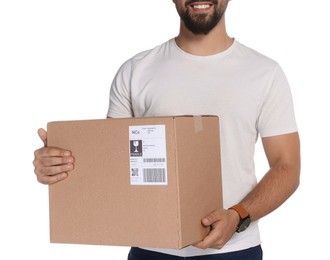 Photo of Happy young courier with cardboard box on white background, closeup