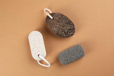 Pumice stones on brown background, flat lay