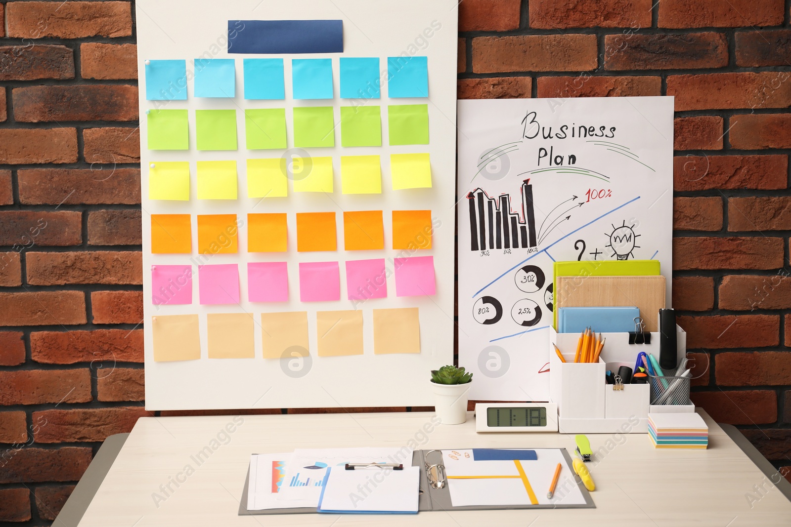 Photo of Business process planning and optimization. Workplace with colorful paper notes and other stationery on table
