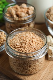 Photo of Dehydrated soy meat and other products on wooden table, closeup