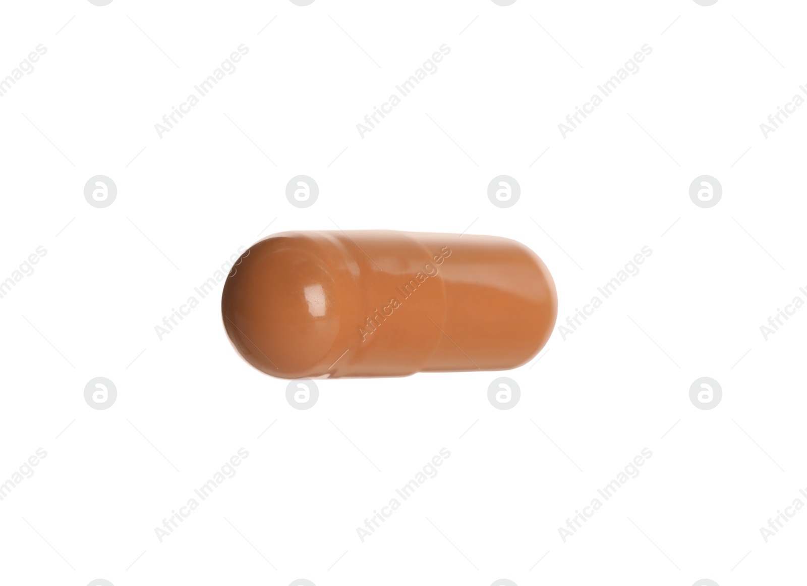 Photo of One brown pill on white background. Medicinal treatment