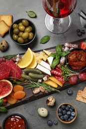 Photo of Setdifferent delicious appetizers served on grey table, flat lay