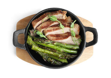 Photo of Tasty meat with asparagus and sprouts in portioned frying pan isolated on white, top view