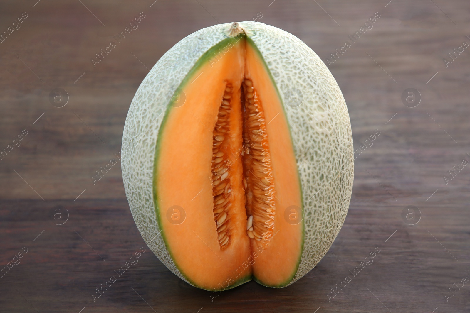 Photo of Cut delicious ripe melon on wooden table, closeup